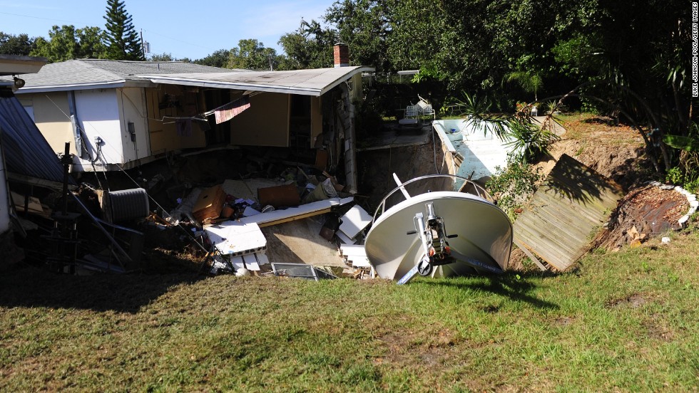 The rear portion of a residential home is consumed by a sinkhole November 14 in Dunedin, Florida.