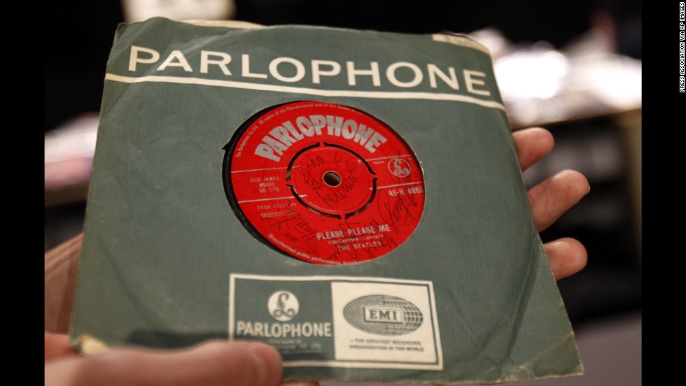 The Beatles released their first album, &quot;Please Please Me,&quot; in the United Kingdom on March 22, 1963. A 7-inch copy of the single, seen here, was signed on both sides by the Fab Four and sold in 2011 for more than £9,000.
