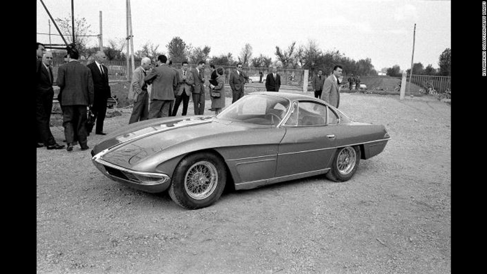 The Lamborghini 350GTV with the body by Franco Scaglione is launched at the Lamborghini Factory, Sant&#39;Agata, Italy, in October 1963. Among the onlookers, with white hair and light-colored jacket, is Piero Taruffi, winner of the last Mille Miglia in 1957. 