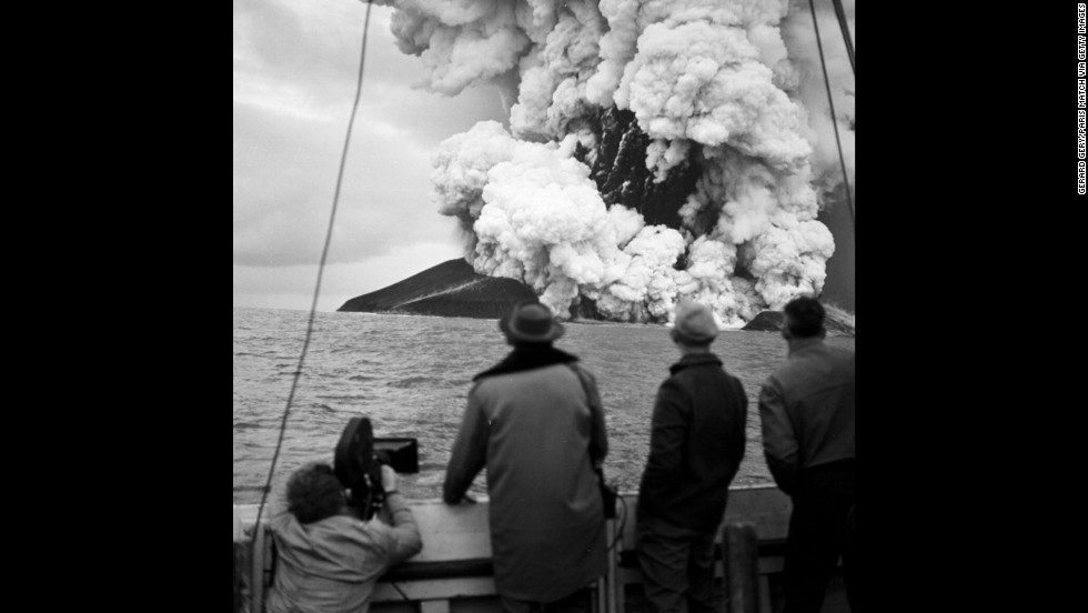 Pierre Mazeaud, Gerard Gery, and Philippe Laffon watch as a new island, Surtsey, is formed from volcanic eruptions off the coast of Iceland on December 2, 1963. 