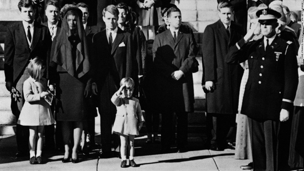 During her father&#39;s funeral in 1963, Caroline stands next to her mother as her brother salutes her father&#39;s coffin.