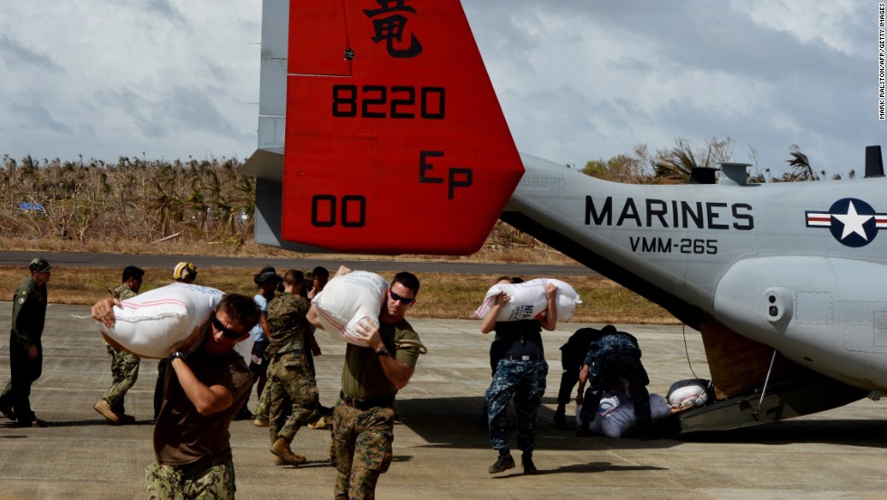 U.S. servicemen unload relief supplies from an Osprey aircraft Thursday, November 21, in Guiuan, Philippines. 