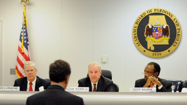 Robert Longshore, left, William Wynne, Jr. and Cliff Walker listen to Sen. Arthur Orr, R-Decatur, address the Alabama Board of Pardons and Paroles on Thursday, November 21 in Montgomery, Alabama.