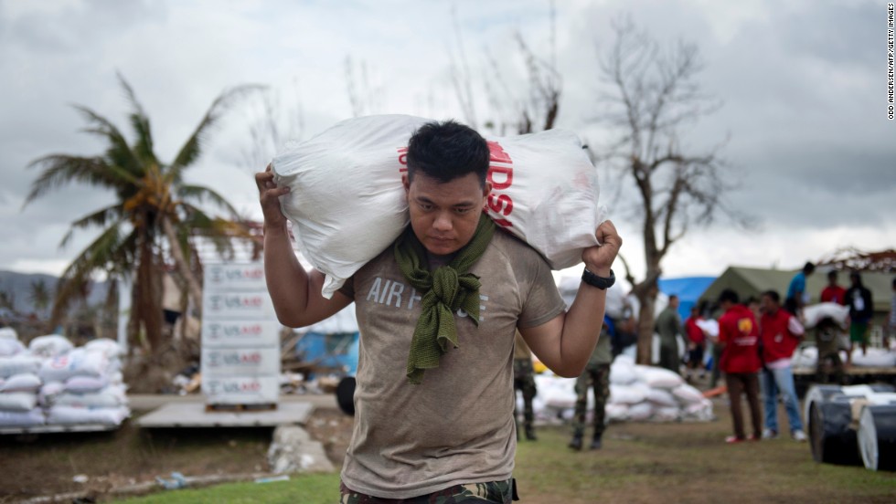A Philippine Air Force crew member loads aid onto a helicopter at the airport in Tacloban, Philippines, on Friday, November 22. 