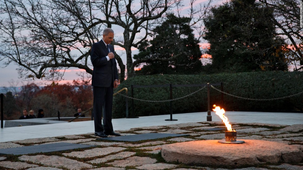 Attorney General Eric Holder pays his respects at Kennedy&#39;s grave on November 22. Holder has been visiting the grave since his youth, and he used to come with his mother before she passed away.