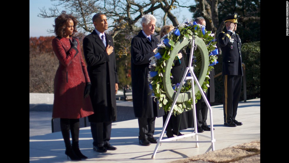 First lady Michelle Obama, President Obama, former President Bill Clinton and former Secretary of State Hillary Clinton pause during a wreath-laying ceremony Wednesday, November 20, at Arlington National Cemetery.