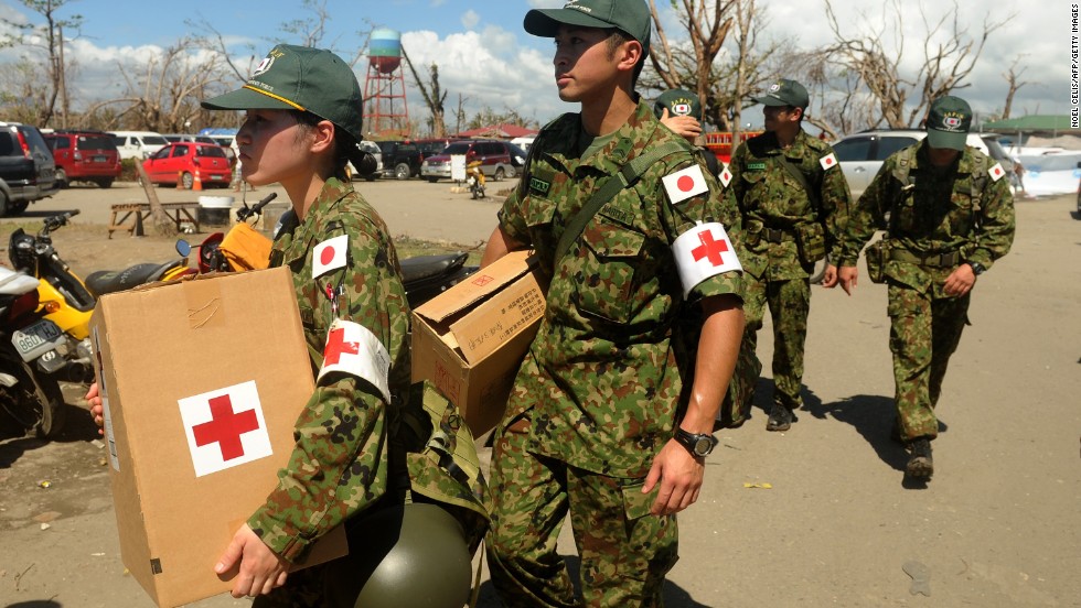 Members of the Japanese Self-Defense Force carry boxes of medicine to be distributed to survivors of typhoon Haiyan in Tacloban on Monday, November 25.