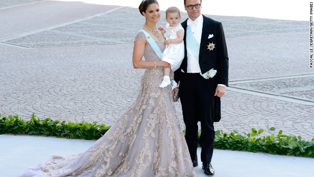Crown Princess Victoria, Princess Estelle and Prince Daniel pose at a 2013 wedding.
