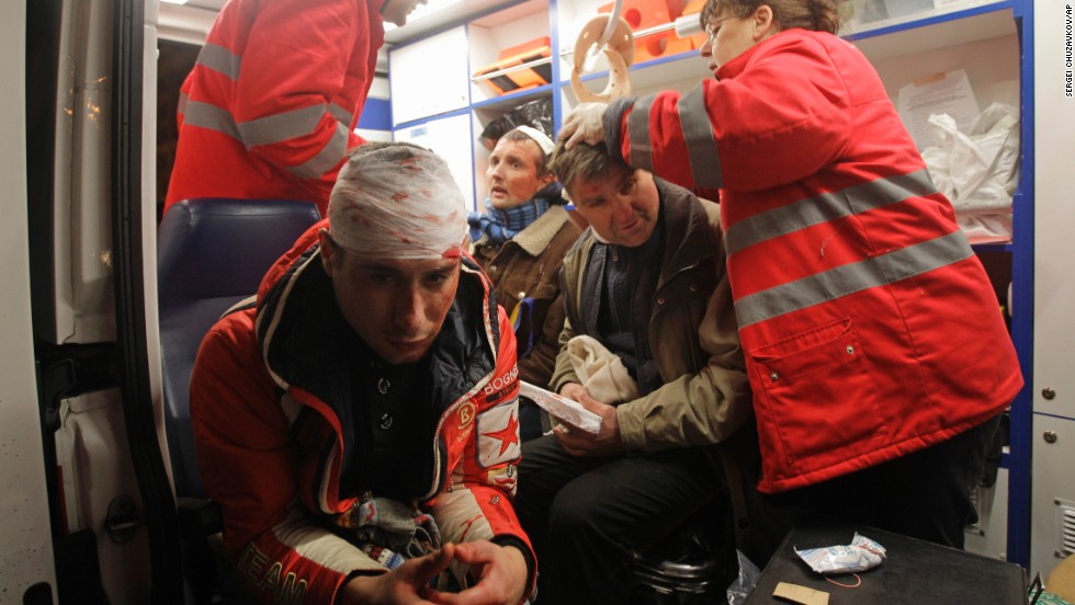 Injured protesters receive medical help in an ambulance after riot police broke up a rally on November 30.