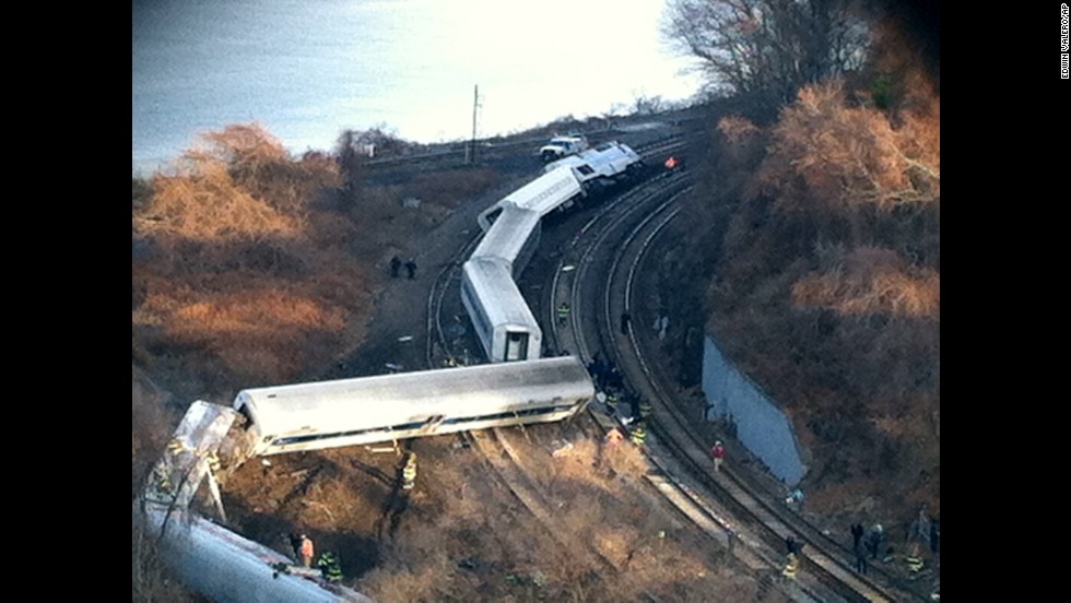 Cars from the train are scattered across the tracks.