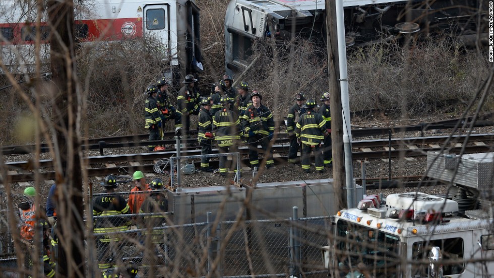 Firefighters and rescue personnel work at the scene of the derailment. 