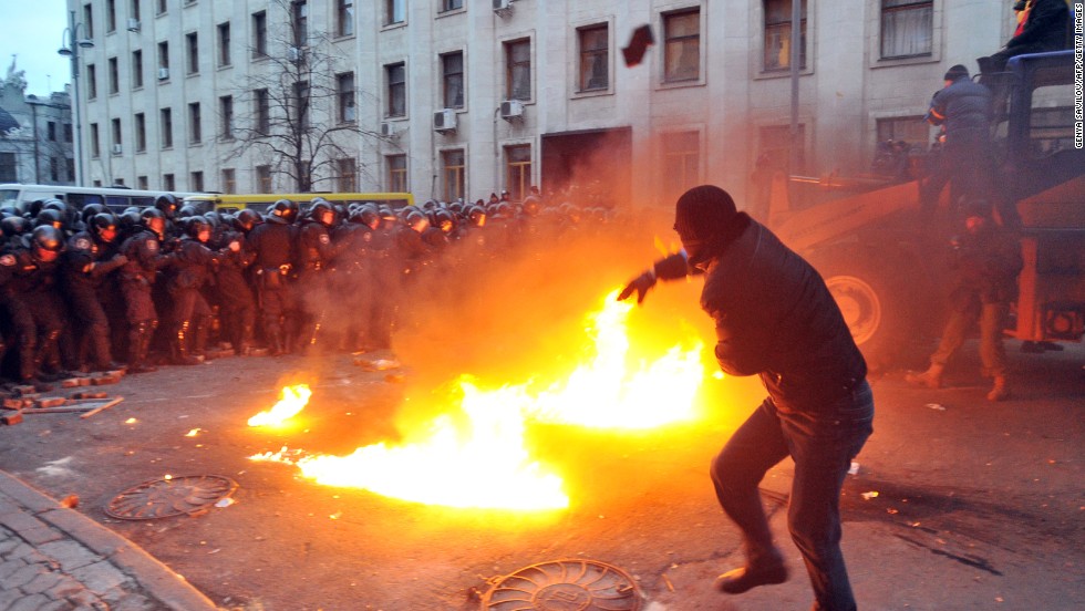 A protester throws stones toward riot police on December 1. The crowd chanted &quot;Revolution&quot; and &quot;Down with the Gang&quot; as it gathered in Independence Square.