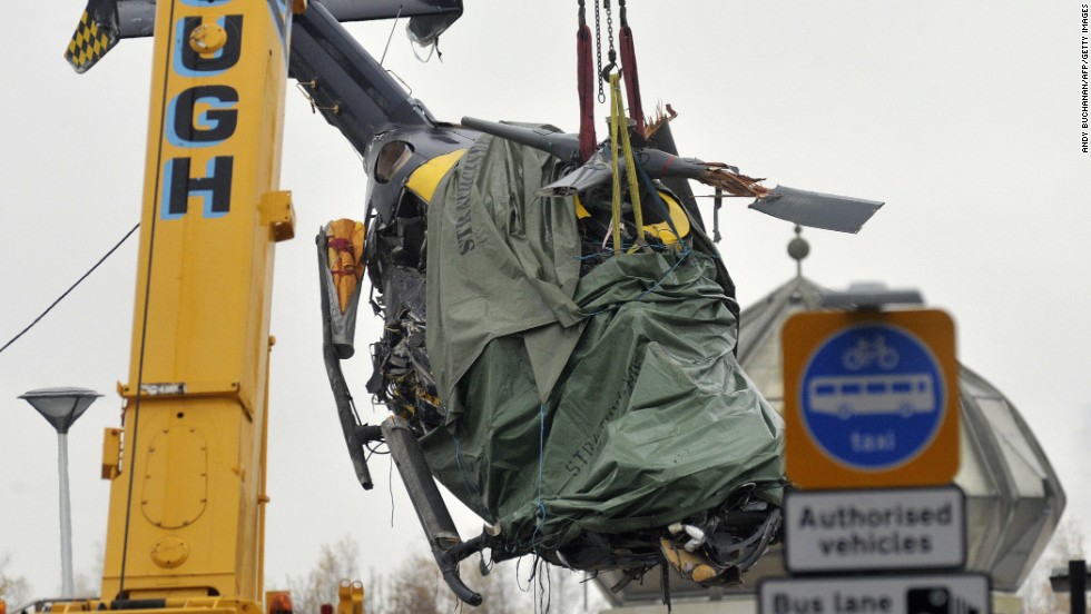 The wreckage of a police helicopter is lifted from the collapsed roof of Clutha pub in Glasgow on Tuesday, December 2. Eight people have been killed and 14 seriously injured since a police aircraft crashed into a downtown pub.