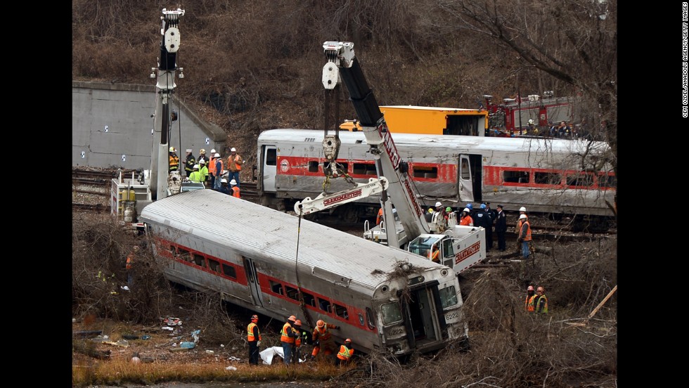 Cranes lift derailed train cars on Monday, December 2.