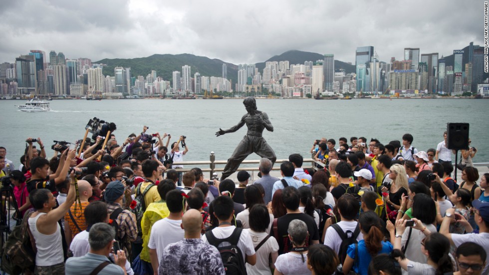 Fans gather around a statue of Bruce Lee in Hong Kong to mark the 40th anniversary of his death on July 20, 2013. Hailed as cinema&#39;s first martial arts hero and a cinematic bridge between the cultures of East and West, Bruce Lee helped put Hong Kong on the world movie map.