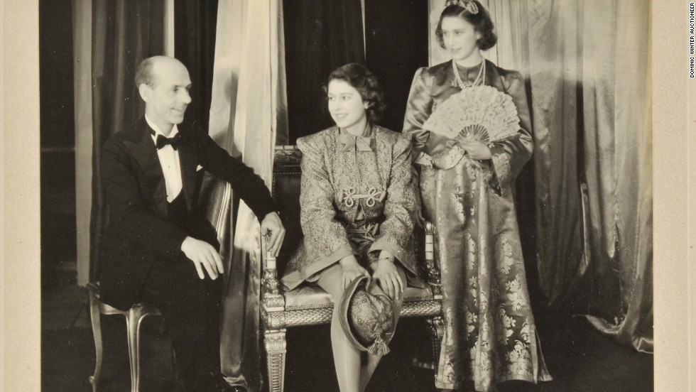 Princess Elizabeth (C) and Princess Margaret (R) on stage in a photograph signed in 1943.