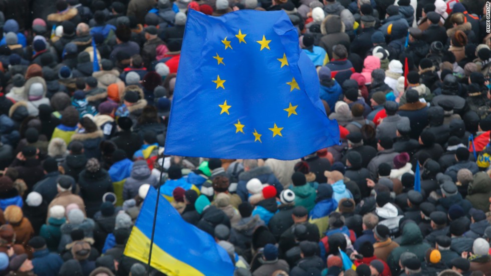 EU flags and Ukrainian national flags fly above a crowd of pro-EU activists in Independence Square on December 8.