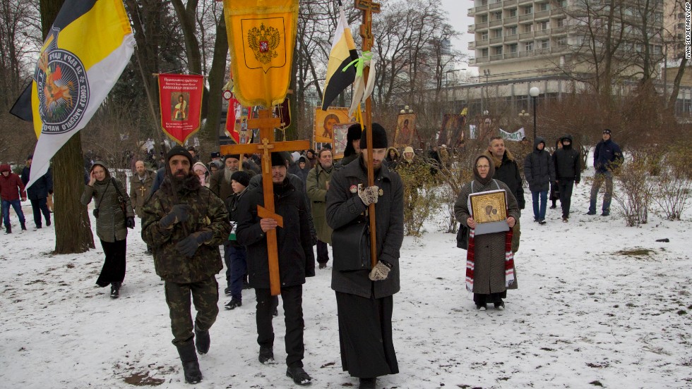 Orthodox believers, carrying icons and crosses, walk during a religious procession outside the parliament building in Kiev on December 6.