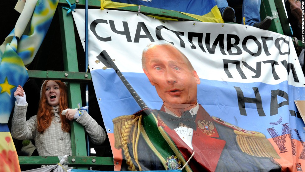 A young protester shouts slogans near a placard depicting Russian President Vladimir Putin and signed &quot;Fare you well!&quot; during the December 8 rally.