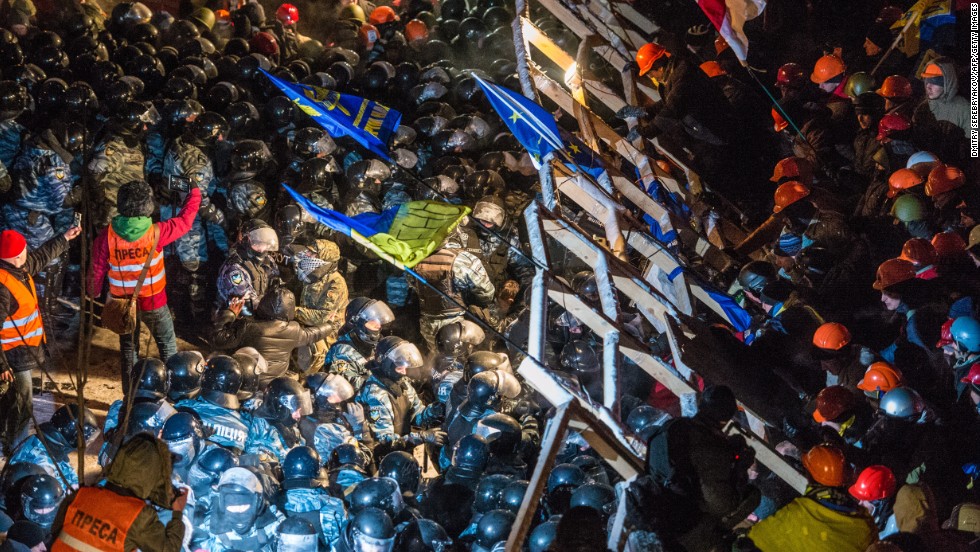 Riot police storm barricades set up by pro-EU protesters in Independence Square on Wednesday, December 11. 
