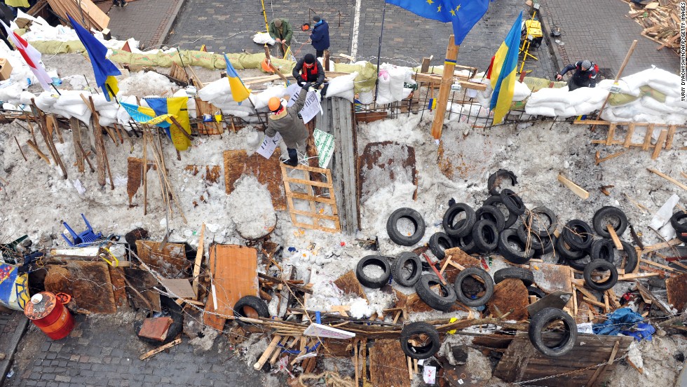 Protesters stand at a barricade in Kiev on December 13.