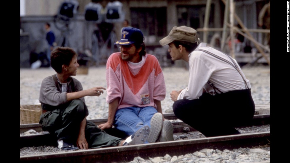Actor Christian Bale, left, Spielberg and John Malkovich talk on the set of &quot;Empire of the Sun&quot; in 1987. The film is taken from J.G. Ballard&#39;s novel based on Ballard&#39;s experiences as a boy in a Japanese prison camp during World War II. 