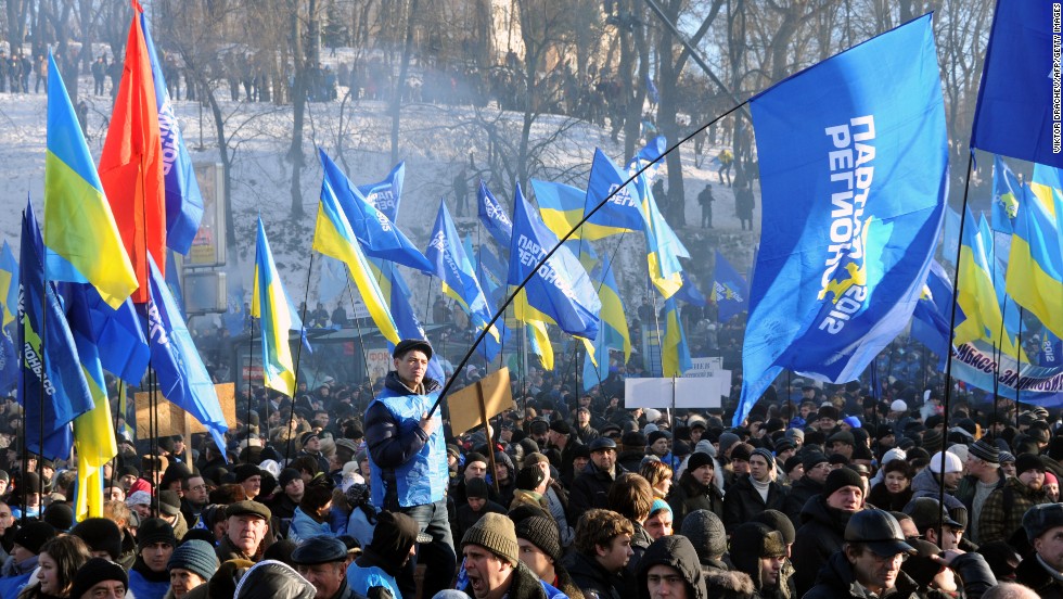 Supporters of the president wave flags of the ruling Party of Regions, as well as Ukrainian flags, during a rally on Kiev&#39;s European Square on December 14.