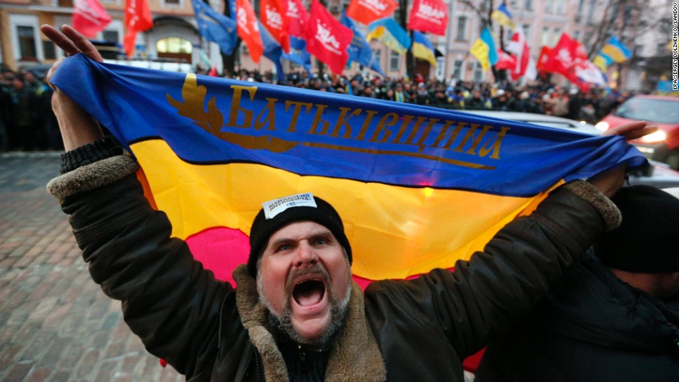 A protester shouts slogans and waves a flag of the Batkivshchyna party during a protest near the Ukrainian Security Service building in Kiev on December 15.