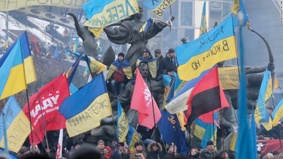 Pro-EU activists wave flags around the monument to the founders of Kiev during a rally in Independence Square on December 15.