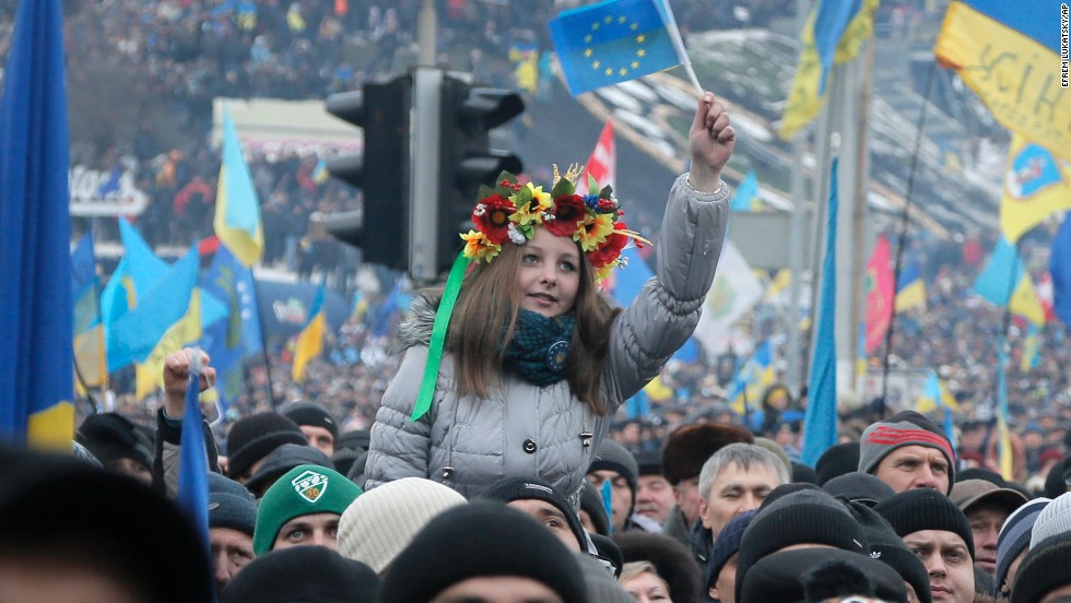 Pro-EU activists, one waving the EU flag, gather during a rally in Kiev on December 15.