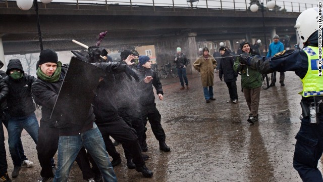 Police try to stop right-wing extremists from attacking an anti-nazi demonstration in Stockholm on December 15. 