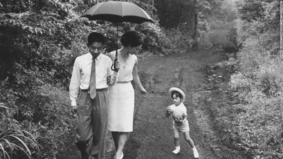 Prince Akihito takes a walk with Princess Michiko and their son Naruhito in 1964. 