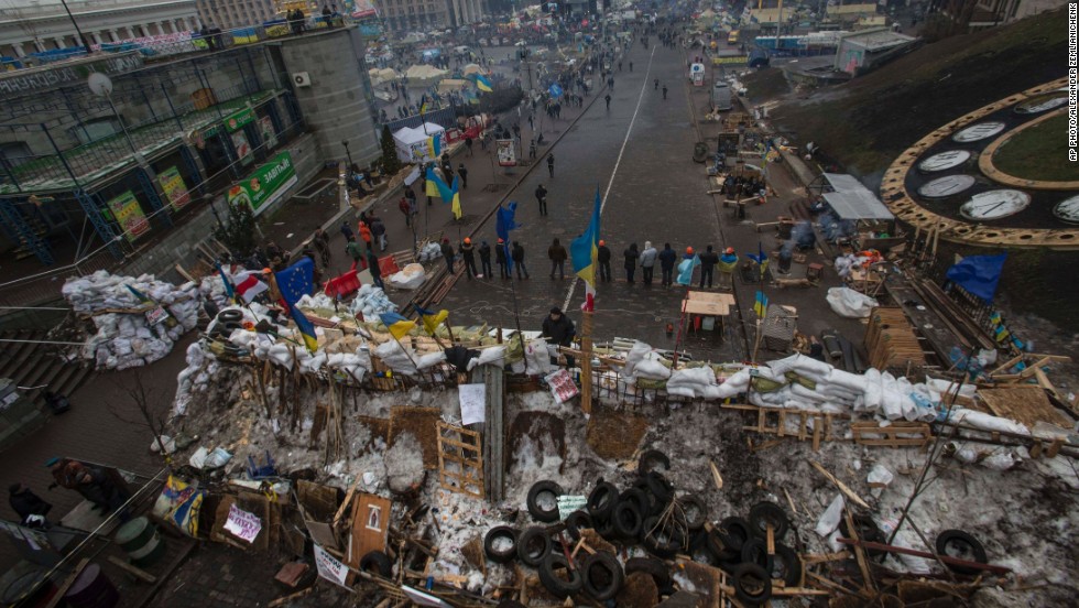 Pro-EU activists stand guard at barricades guarding a heavily fortified tent camp in Independence Square on December 17.