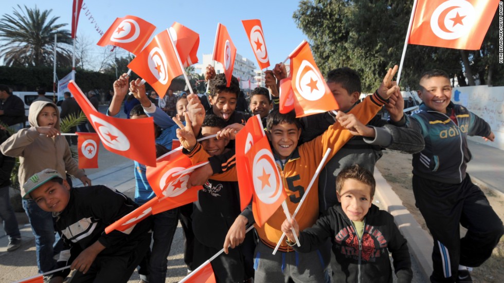 Children wave the national flag in Mohamed Bouazizi square.