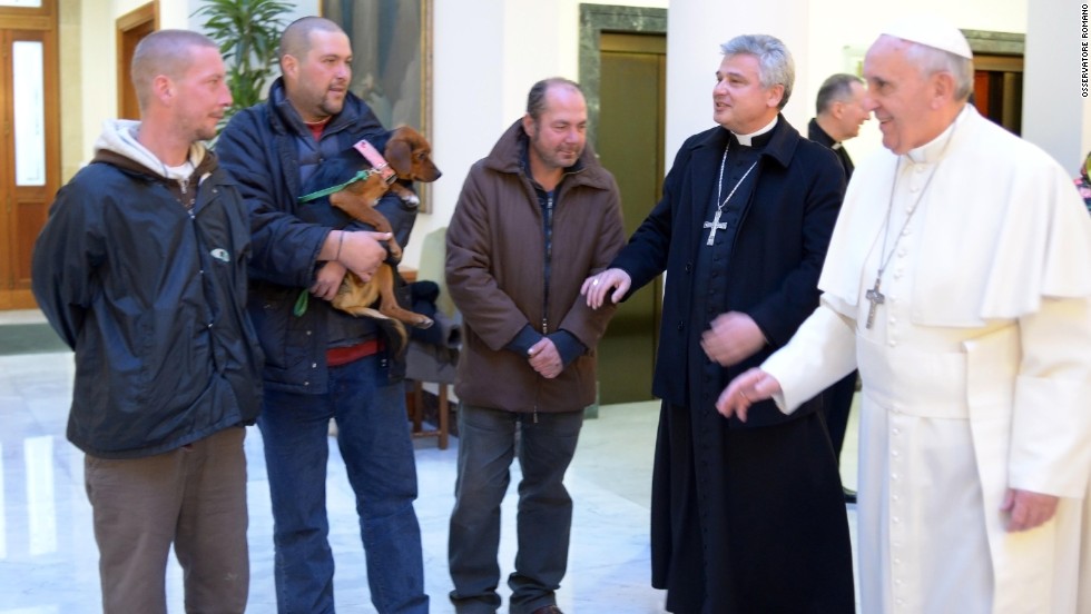 Pope Francis marked his 77th birthday in December 2013 by hosting homeless men at a Mass and a meal at the Vatican. One of the men brought his dog. 