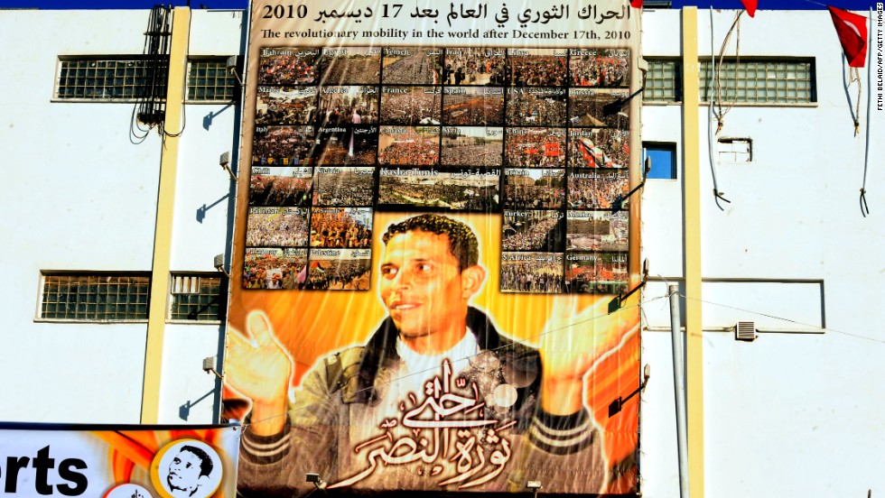 A giant portrait of Mohamed Bouazizi hangs on the wall in the central town of Sidi Bouzid.&lt;a href=&quot;http://cnn.com/2011/WORLD/africa/01/16/tunisia.fruit.seller.bouazizi/&quot;&gt; The 26-year old fruit seller who struggled with poverty &lt;/a&gt;set himself on fire in front of a government building on December 17, 2010 sparking riots across the country. Al Bouazizi died of his injuries on January 4, 2011.