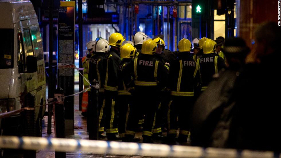 Firefighters confer at the scene. Nick Harding, the London Fire Brigade&#39;s Kingsland Station manager, said about 720 people were inside the theater when a section of the ceiling collapsed, taking parts of the balconies with it.