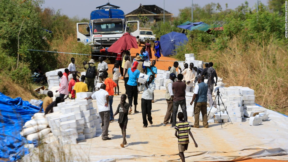 People gather to receive emergency food rations from the World Food Programme at a makeshift camp on December 23. 