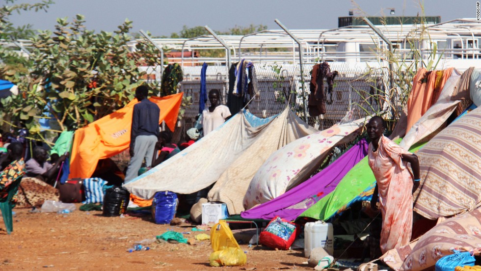 People take refuge December 22 near a camp of Japan&#39;s Ground Self-Defense Force, which is part of the U.N. peacekeeping mission in Juba. 