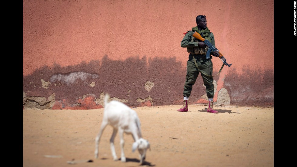 A soldier with the Malian army patrols a street in Gao, Mali, with an AK-47 on February 25, 2013.