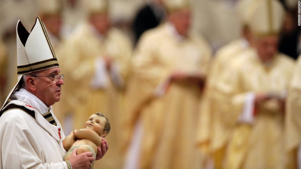 The Pope carries a statue of baby Jesus during the celebrations. On Christmas Day, tens of thousands of pilgrims are expected to flood St. Peter&#39;s Square to hear his message to the world.
