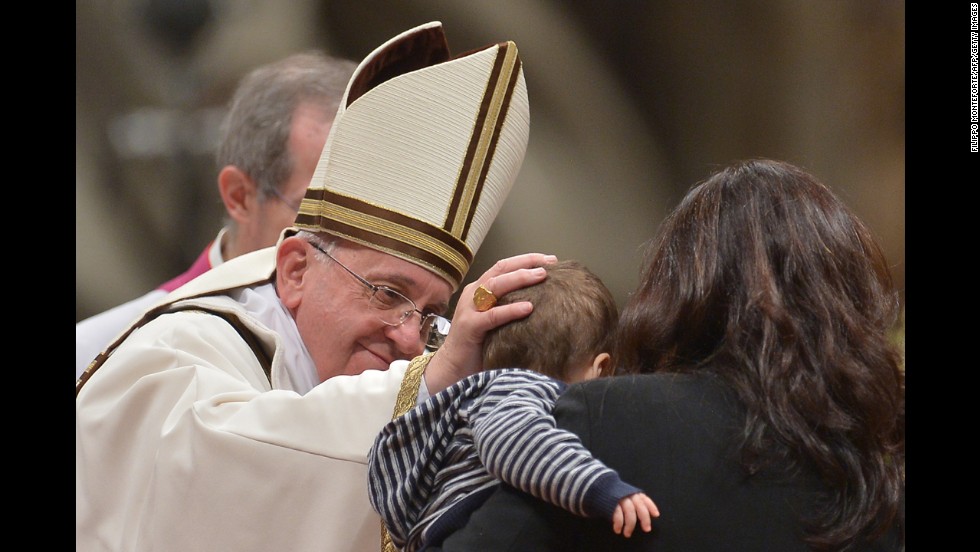 Pope Francis greets a child during the service. Before the Mass, pilgrims gathering in Vatican City told CNN they were excited to celebrate with the Pope.