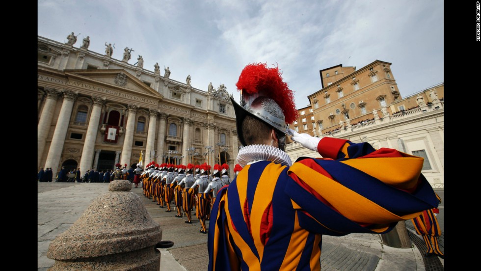 Swiss guards march prior to the start of the Pope&#39;s message.