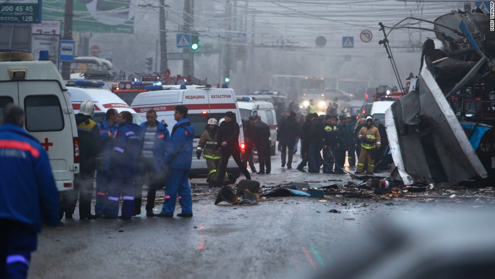 Experts, firefighters and police officers examine the scene of the blast.