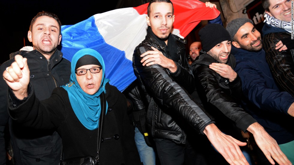 The &quot;quenelle&quot; gesture has been popularized by the anti-establishment French comedian Dieudonne, who has been condemned in France for anti-Semitism. Here people perform the &quot;quenelle&quot; in front of  Dieudonne&#39;s theater, while protesting against French interior minister Manuel Valls who has called for Dieudonne&#39;s performances to be banned. 