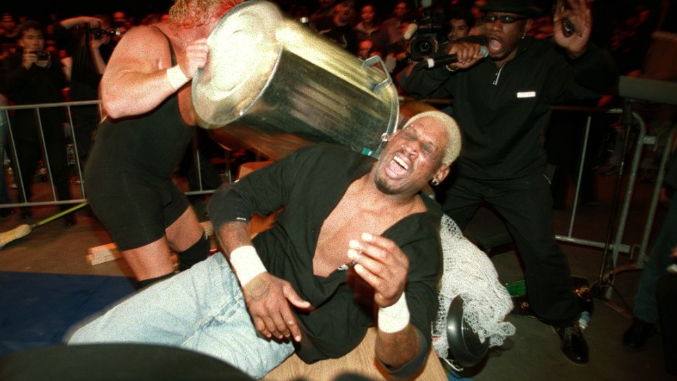 Rodman is hit with a trash can by Curt Hennig during a pro wrestling match in Sydney in 2000.