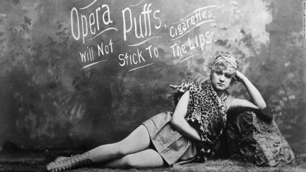 A model is seen lying down in an advertisement for Opera Puffs Cigarettes.