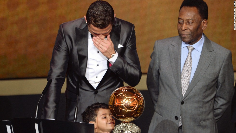 While the Portuguese star is overcome by emotion, his son Cristiano Ronaldo Jr cannot hide his glee at his father&#39;s prize. 