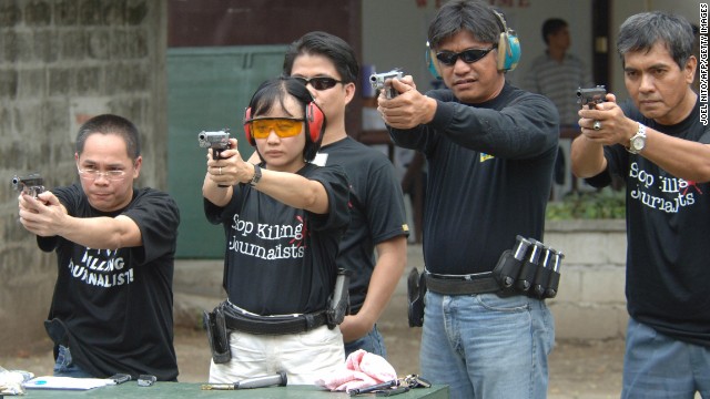 Journalists learn to shoot pistols in Manila in 2005 as part of an advocacy group&#39;s campaign to curb attacks against  the media in the Philippines by arming reporters.