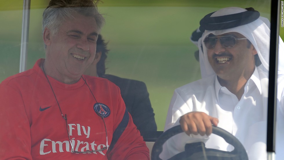 Paris Saint-Germain&#39;s coach Carlo Ancelotti rides in a golf buggy with Qatari Crown Prince Sheikh Tamim bin Hamad al-Thani, the French football club&#39;s owner. 